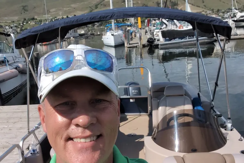 Sean Phillips on a pontoon boat at the marina in Okanagan Landing