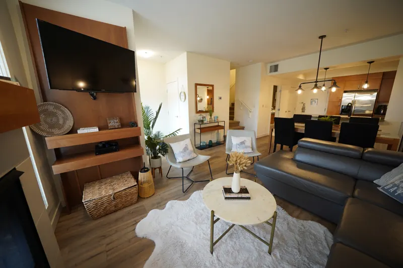 Living room with fireplace and TV wall in a Strand condo