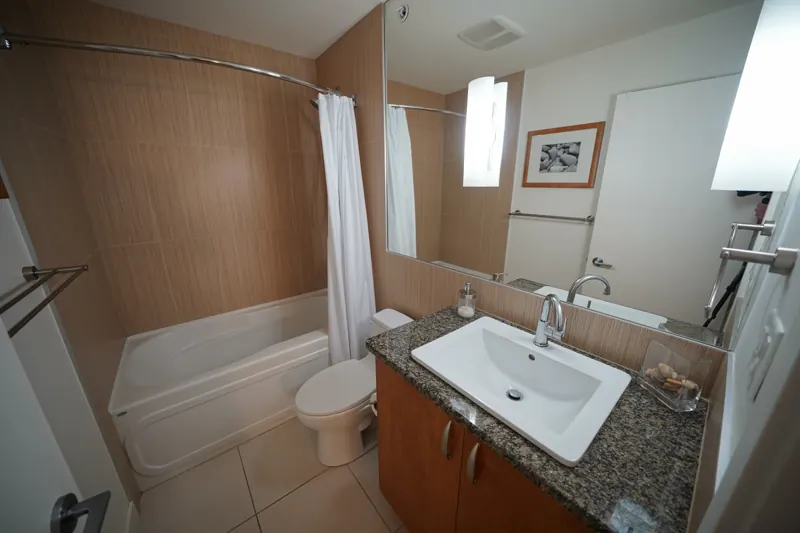 Bathroom with tub and granite vanity