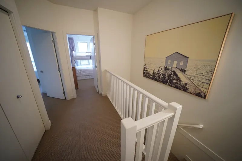 Upper hallway and stairs in a two-storey Strand townhome